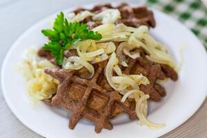 fried liver waffles with onions and herbs photo