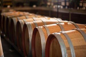 Old wooden wine barrels stacked in a cellar in order photo