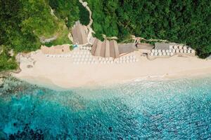 Aerial view of ocean and tropical beach with umbrellas in Bali photo
