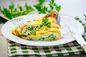 fried omelette stuffed with herbs, parsley, dill photo