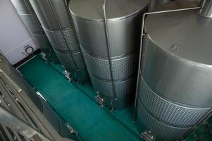 Wine fermentation tanks in modern wine factory photo