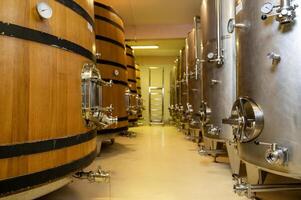 Wine fermentation tanks in modern wine factory photo