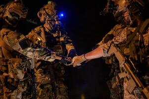 Soldiers ready to fire during Military Operation at night photo
