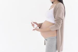 Beautiful pregnant woman applying moisturizing, stretch mark cream on belly, fertility infertility treatment, IVF, future maternity concept photo