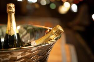 Bottle of wine chilling in ice bucket photo