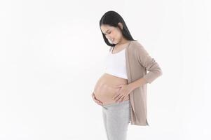 Beautiful pregnant woman applying moisturizing, stretch mark cream on belly, fertility infertility treatment, IVF, future maternity concept photo