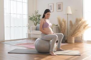 Healthy pregnant woman exercising and doing prenatal yoga, meditation, working out, yoga, pregnancy concept. photo
