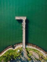 Top view of pier and sea with sunlight, aerial view photo