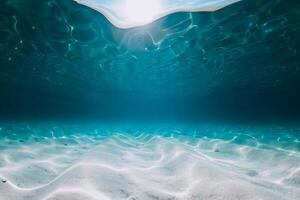 Tropical blue ocean with white sandy sea bottom underwater in Hawaii photo