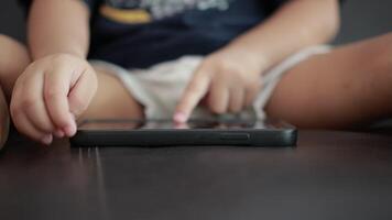 Closeup of children hand using phone on sofa in house video