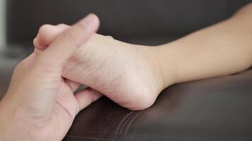 Closeup of a children foot on sofa video