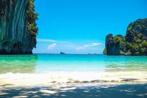 Aerial panorama of Thailand's verdant, lush tropical island, National Park Island, with blue and aquamarine the sea, and clouds shining by sunlight in the background. photo