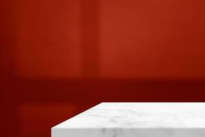 Minimal White Marble Table Corner with Shadow and Light Beam on Red Concrete Wall Background, Suitable for Product Presentation Backdrop, Display, and Mock up. photo
