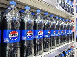 Bangkok, Thailand May 11, 2024 Pepsi on the shelf in Supermarket sign. Pepsi is a carbonated soft drink with a cola flavor, manufactured by PepsiCo. photo