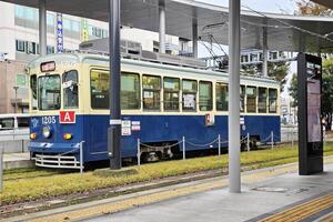 Kumamoto, Japan November 17, 2023 Kumamoto city tram Number 1205. It was originally a Type 200 electric car produced in the late 1950s photo