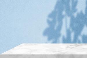 White Marble Table Corner with Light Beam, Shadow, and Spotlight on the Dark Shade of Cyan Blue Concrete Wall Background photo