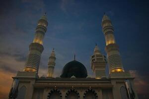 mosque at the evening and drammatic sky background photo