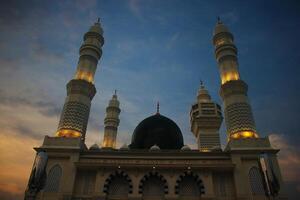 mosque at the evening and drammatic sky background photo