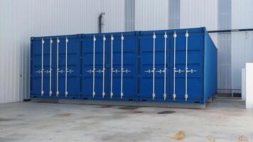 A row of blue shipping containers. photo