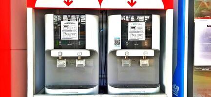 Free drinking water machine for public service at train station Bekasi. West Java, Indonesia - April 8 2024 photo