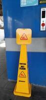 Caution wet floor sign cone at train station. Bekasi, West Java, Indonesia - April 8 2024 photo