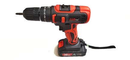 Electric red cordless screwdriver drill with charge the battery isolated on white background. Professional home repair tool. Bekasi, West Java, Indonesia - May 17 2024 photo