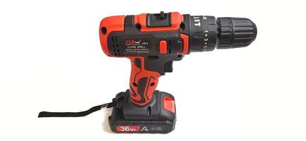 Electric red cordless screwdriver drill with charge the battery isolated on white background. Professional home repair tool. Bekasi, West Java, Indonesia - May 17 2024 photo