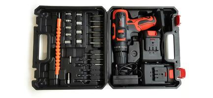 Electric red cordless screwdriver drill with charge the battery isolated on white background. Professional home repair tool. Bekasi, West Java, Indonesia - May 17 2024 photo