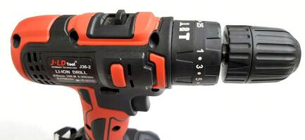 Electric red cordless screwdriver drill with charge the battery isolated on white background. Professional home repair tool. Bekasi, West Java, Indonesia - May 17 2024 photo