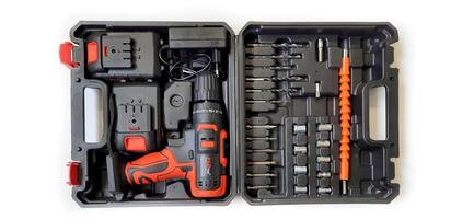 Electric red cordless screwdriver drill with charge the battery isolated on white background. Professional home repair tool. Bekasi, West Java, Indonesia - May 17 2024 photo