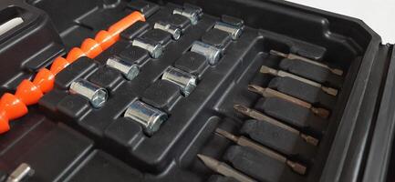 Electric red cordless screwdriver drill with charge the battery isolated on white background. Professional home repair tool. Bekasi, West Java, Indonesia - May 17 2024 photo