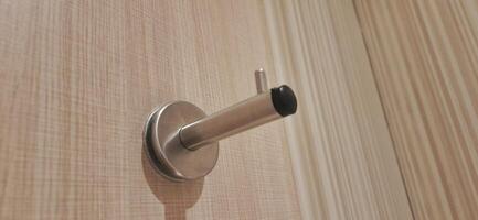 Door stopper wall. Stainless magnetic door in toilet photo