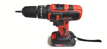 Electric red cordless screwdriver drill with charge the battery isolated on white background. Professional home repair tool. Bekasi, West Java, Indonesia - May 17 2024 photo