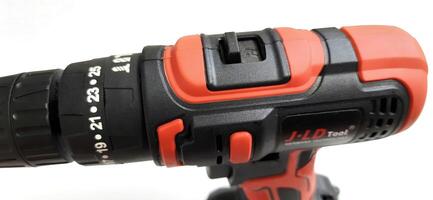 Electric red cordless screwdriver drill with charge the battery isolated on white background. Professional home repair tool. Bekasi, West Java, Indonesia - May 17 2024 photo