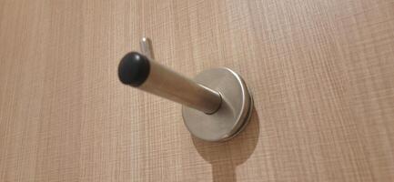 Door stopper wall. Stainless magnetic door in toilet photo