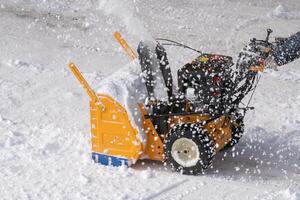 Snow blower machine is effectively removing snow from street road after winter blizzard photo