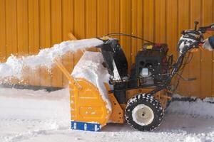 Snow blower effectively removes snow that accumulated on city streets after winter snowstorm photo