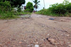 view of a dirt road in a village with a natural concept photo