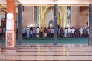 Surabaya, Indonesia - may 24th 2024 - people praying in the mosque photo