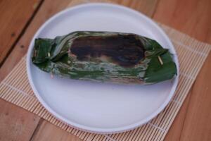 Grilled rice served on a wooden plate. photo