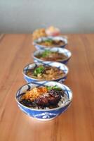 japan style beef with rice and vegetables on wooden table. photo