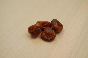Dates fruit on wooden background. Healthy eating and dieting concept. photo