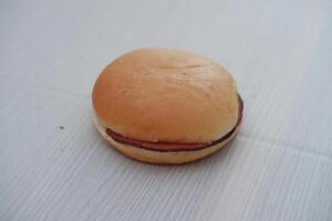 Hamburger bun on a wooden table. Close up. photo