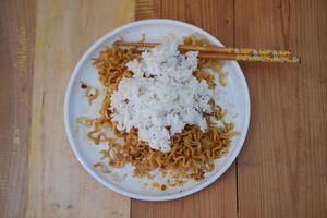 A plate with a combination of noodles and rice, creating a delicious and satisfying meal. photo