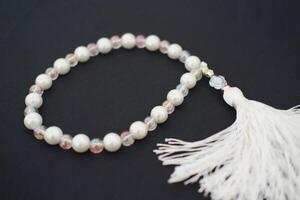 prayer beads on a black background close up photo