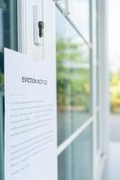 document with the text eviction notice, Civil servant sticks a notice of eviction of the tenants hangs on the door of the house, debt, property, loan, agent, bankruptcy, dispossess, problem photo