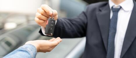 lease, rental car, sell, buy. Dealership manager send car keys to the new owner. Sales, loan credit financial, rent vehicle, insurance, renting, Seller, dealer, installment, car care business photo