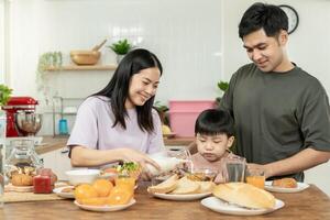 family time, breakfast, activities together during the holidays. Parents and children are having a meal together during the holidays. New home for family on morning, enjoy, weekend, vacant time photo