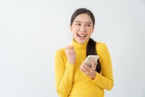 Asian beautiful woman exited surprise face expression . female feels shocked with the phone. exciting smile and happy adorable rejoices. Very enjoy and fun relax time. wow, girl holding smartphone. photo