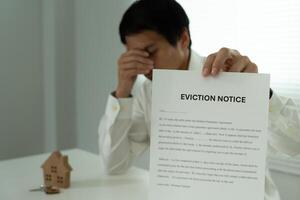 document with the text eviction notice, Civil servant sticks a notice of eviction of the tenants hangs on the door of the house, debt, property, loan, agent, bankruptcy, dispossess, problem photo